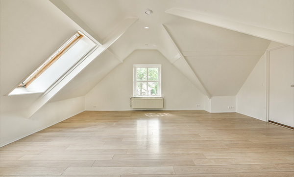 bright spacious attic room with sloped ceiling and wooden flooring featuring a large window and natural light ideal for six design inspirations