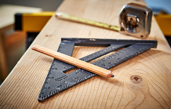 triangular ruler pencil on wooden surface with tape measure measuring tools for accurate woodworking 3 dimensions